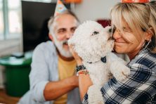 A woman gets a kiss from her dog on her birthday.