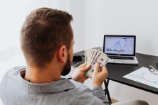 A man looks at money in his hands