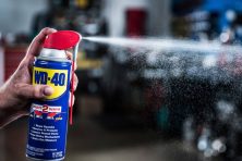A man sprays WD-40.