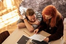 A couple go over their credit card debt on their computer.