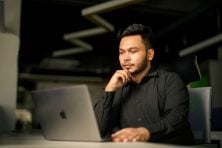 A man looks at a laptop.
