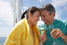 A couple spend time on a yacht while drinking champagne.