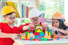 Three children play with blocks at their local library.