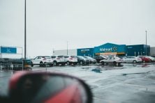 A view of the front of a Walmart from a parking lot.