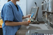 A pharmacist adds meds to a box.