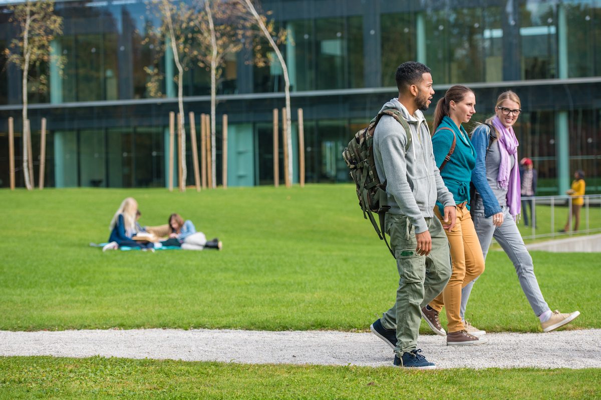 University students walking together in campus.