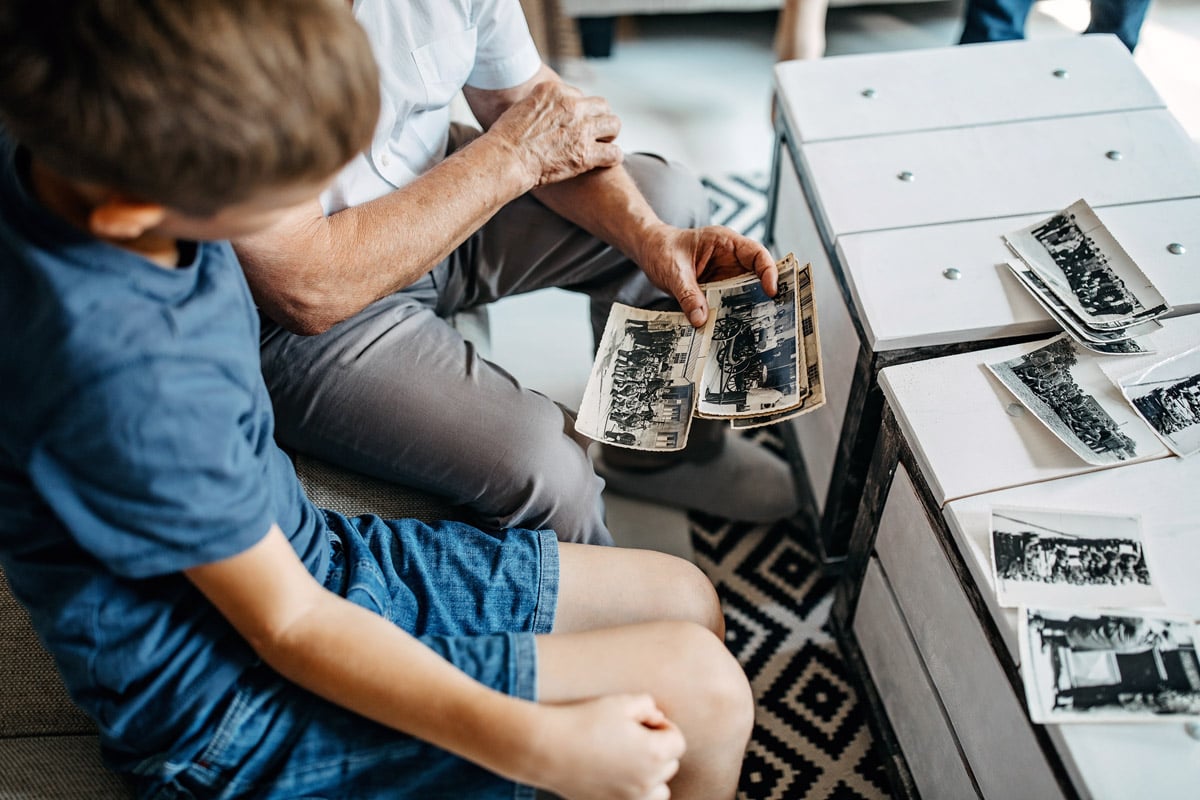 A grandfather shows his grandson old photos. This story goes over how to digitize your old photos on a budget. 