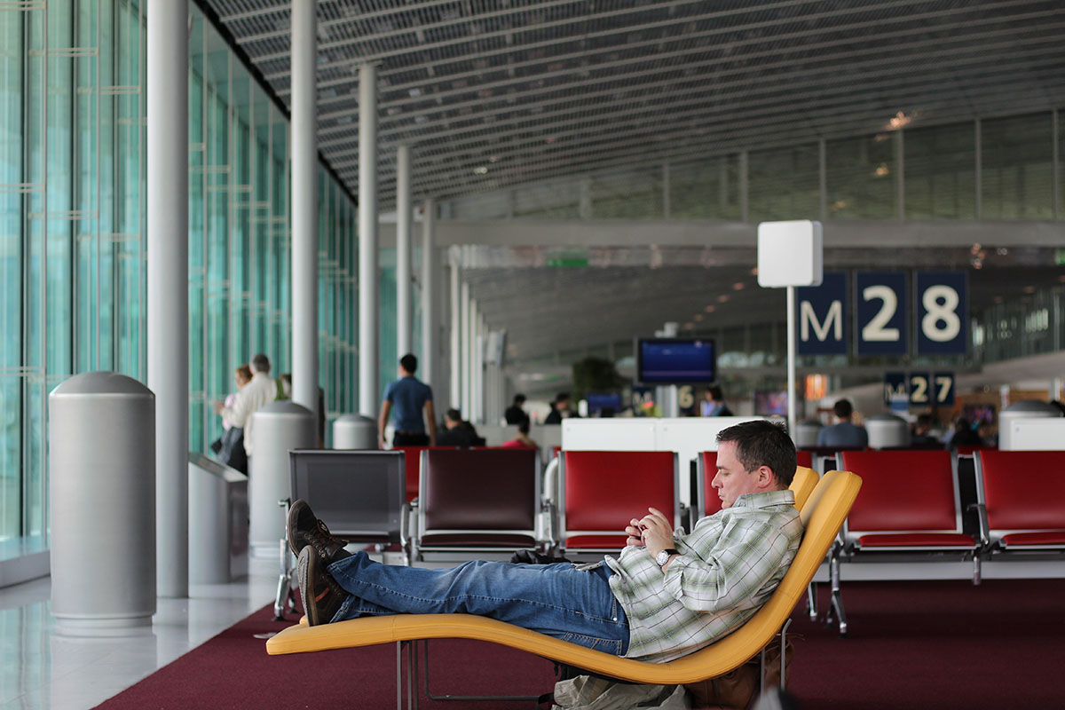 man lounging at airport terminal
