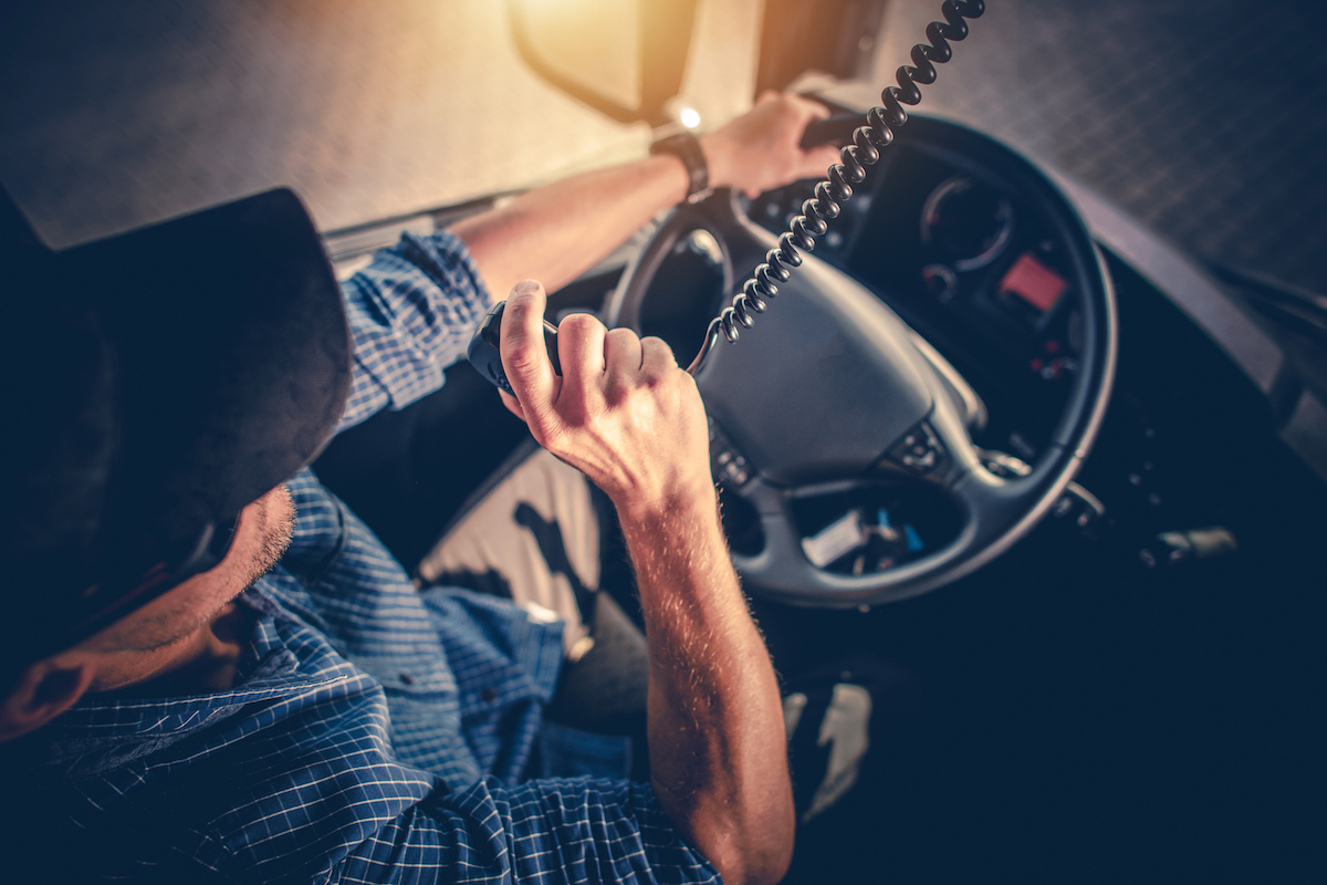over head photo of truck driver talking on radio