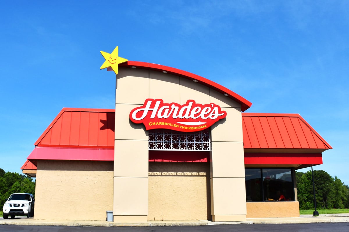 A Hardee's fast food store front is photographed from the outside of the establishment.