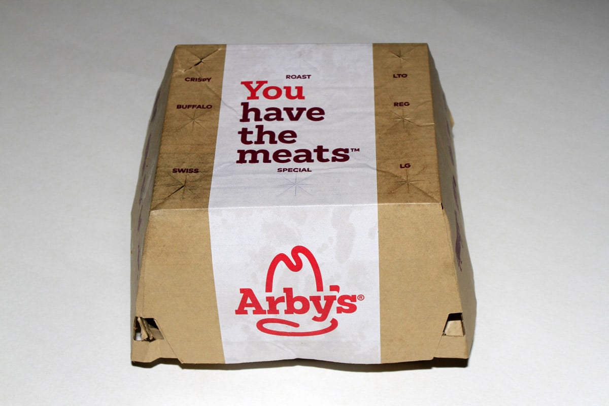 A box is photographed containing an Arby's sandwich.