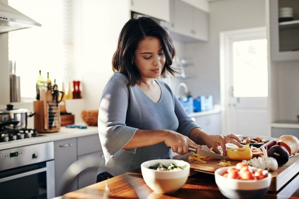 Person meal prepping at home to save money on food costs