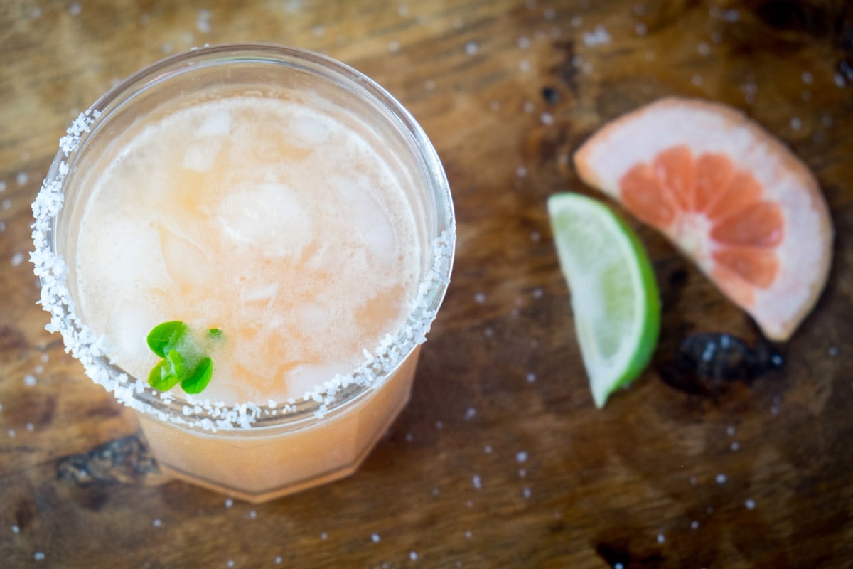 A Paloma is photographed with salt and lime in it. 