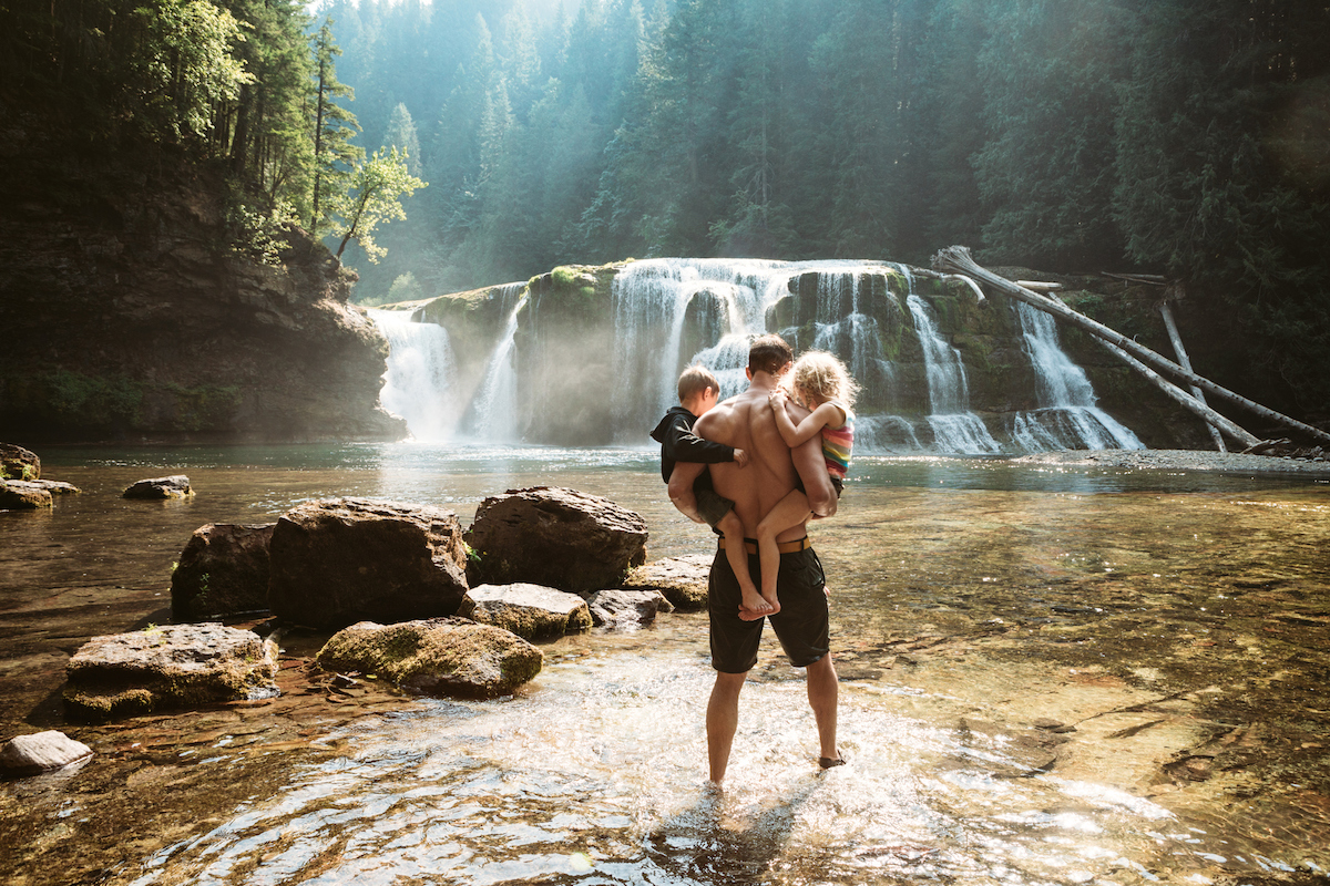 a family looking at a waterfall