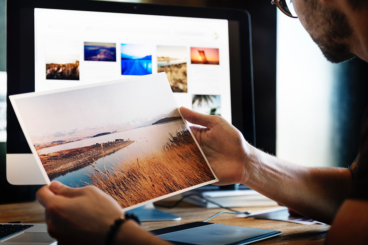 man reviewing photos on his computer