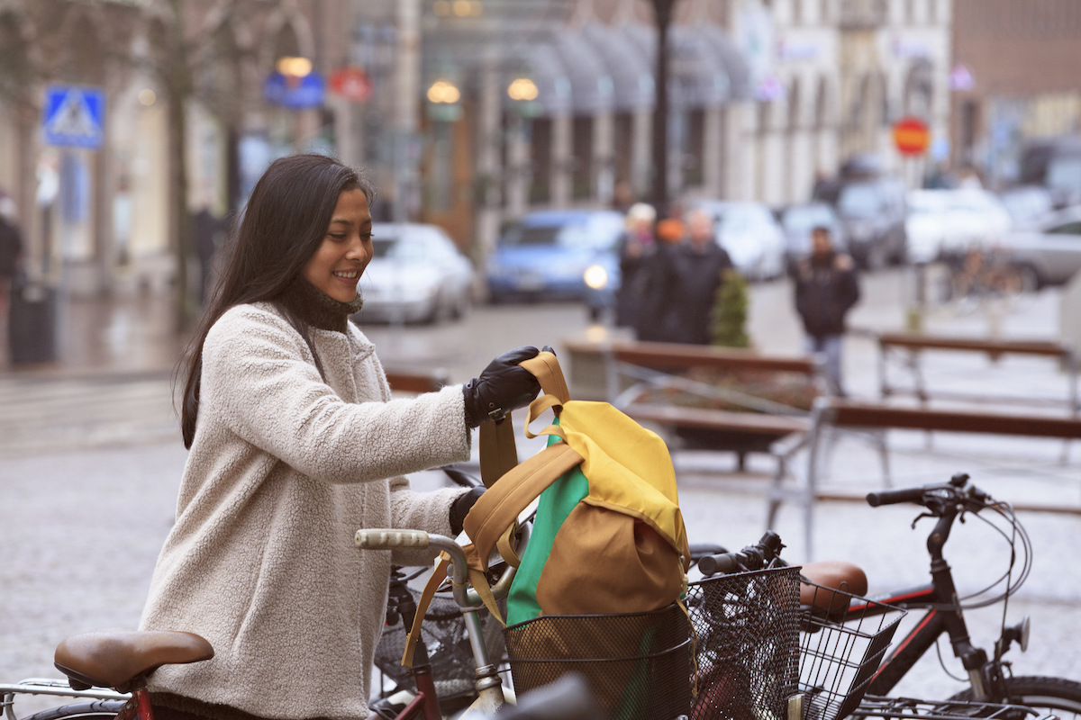 Smiling woman cycling in Helsingborg, Sweden