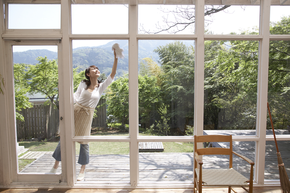 Woman on patio cleaning windows
