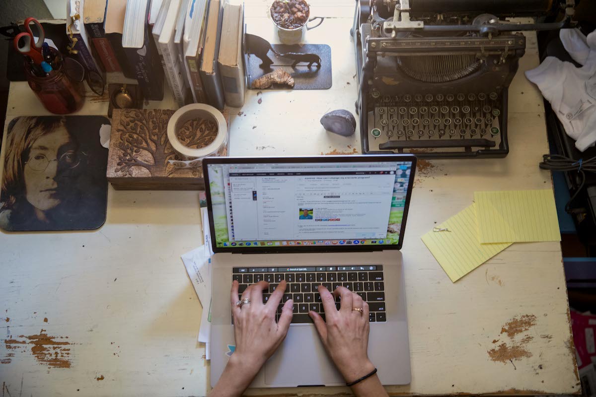 a woman typer on her laptop at her desk from home