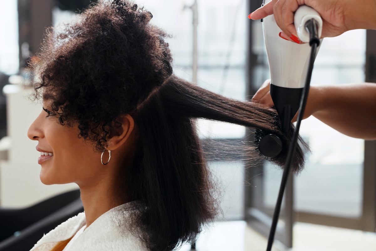 A woman gets her hair done at a salon. 
