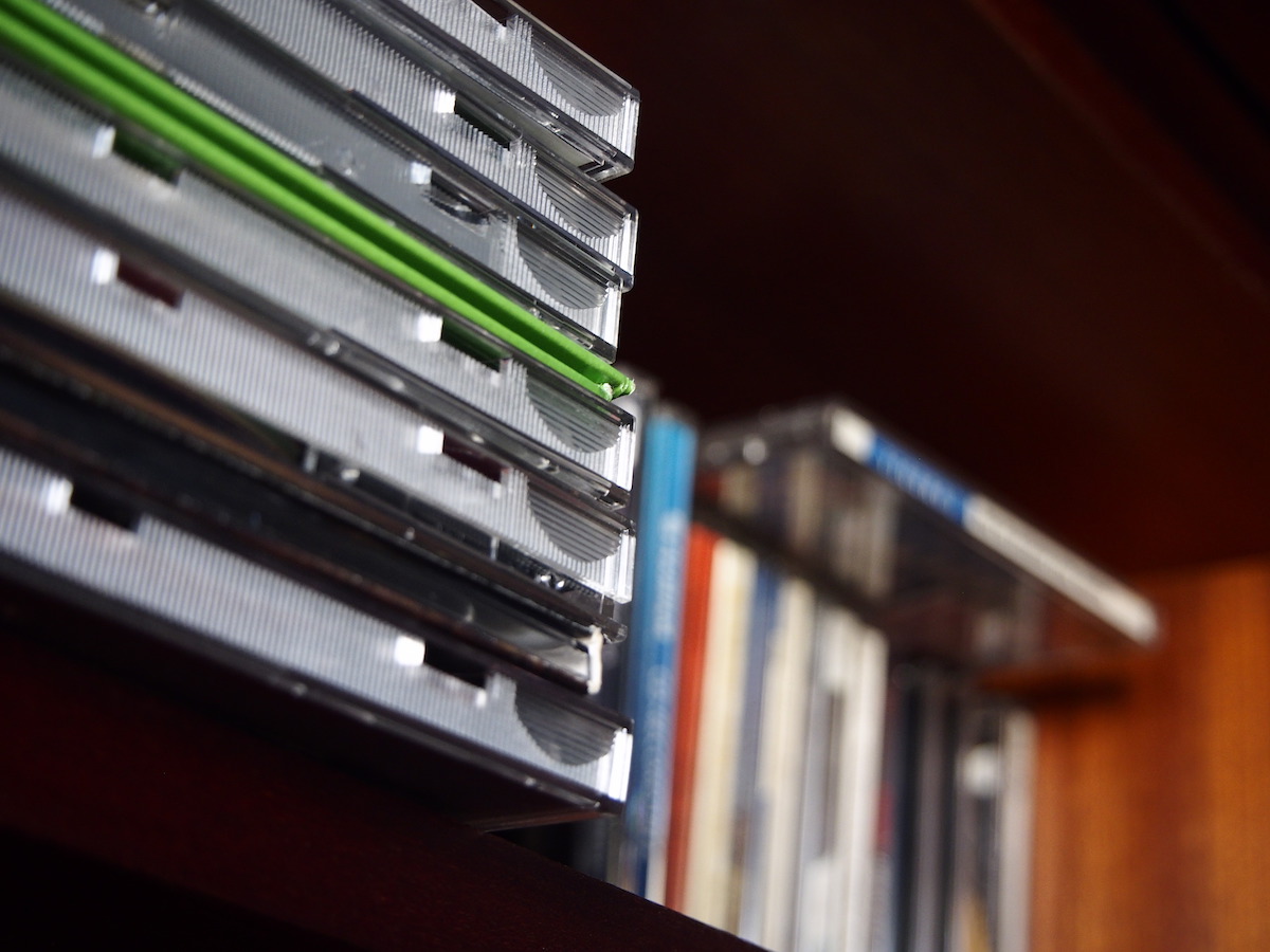 a stack of CDs on a shelf.