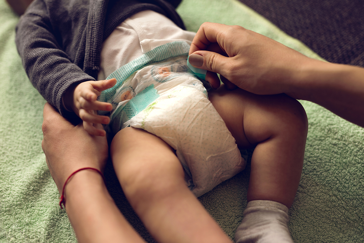 mother changing diapers