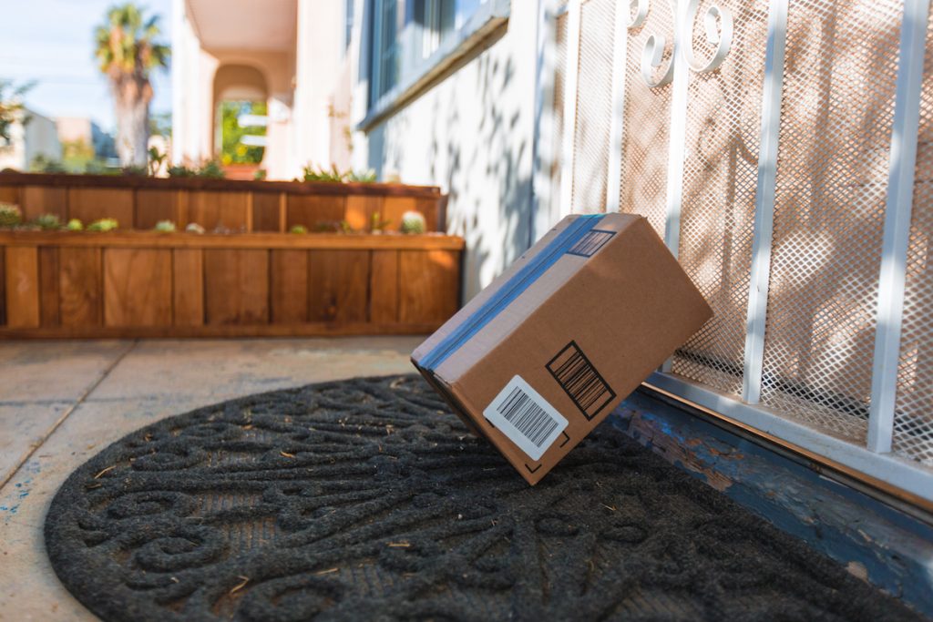 Cardboard package delivery leaning against front door