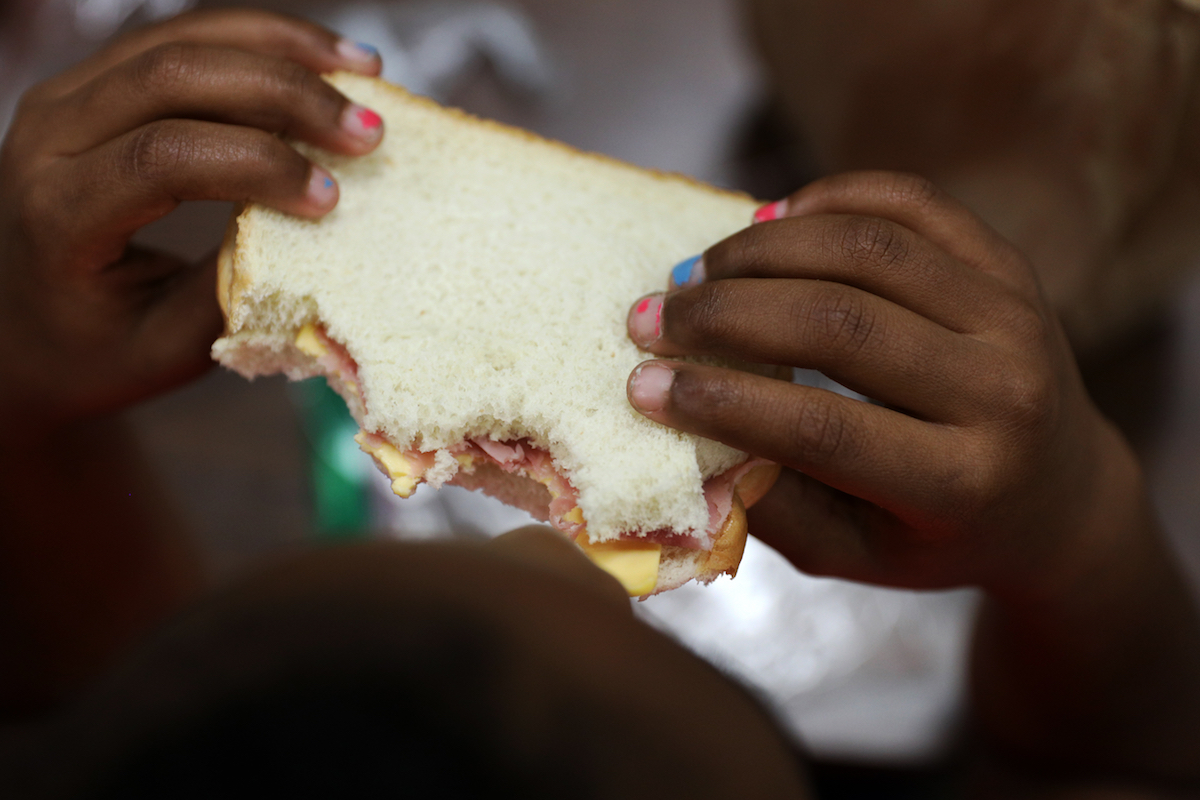 A child eats a free sandwich at Northside Boys and Girls Club Monday, June 5, 2017 in St.Petersburg, Fla.