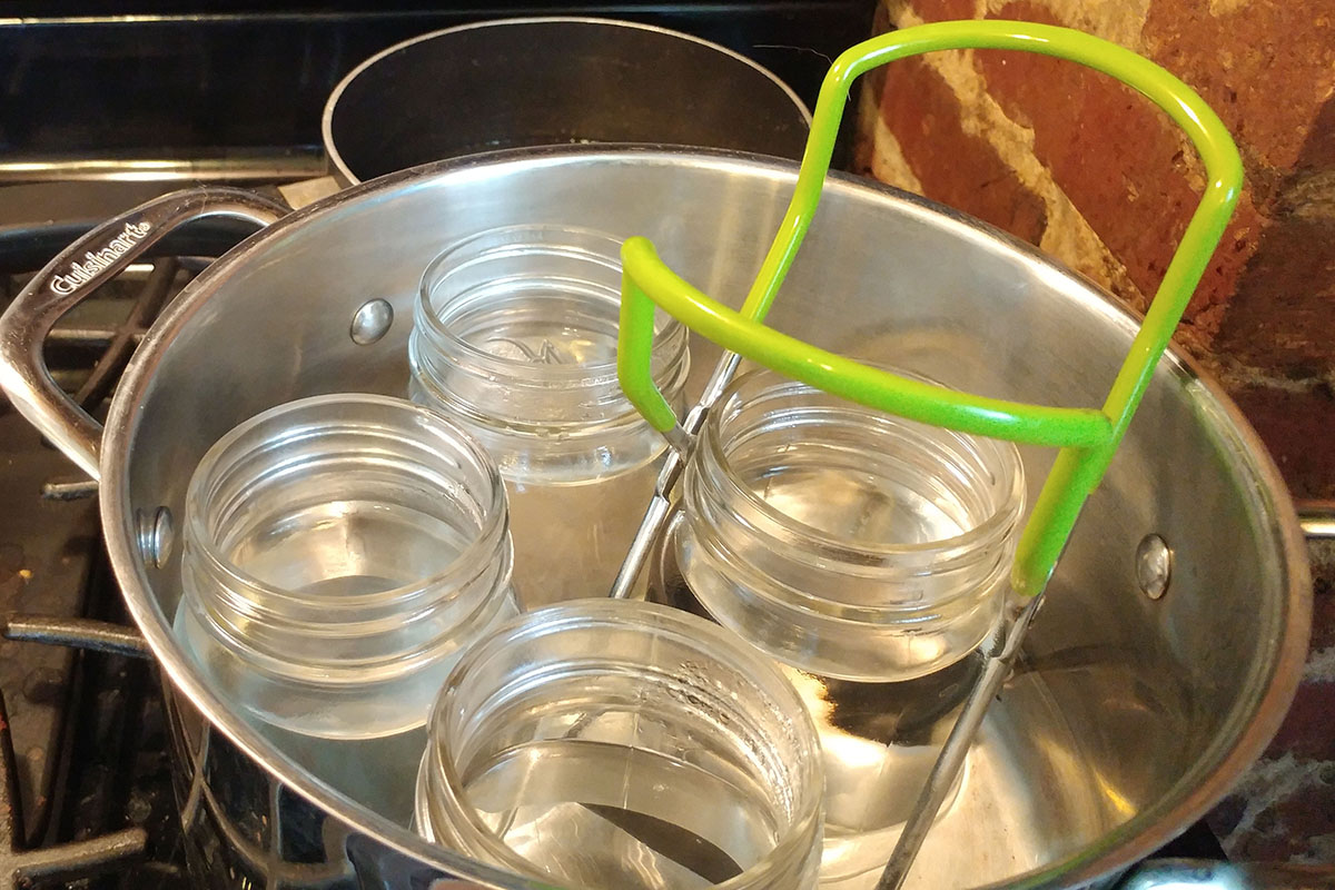 Sanitized jars are taken out of boiling water.