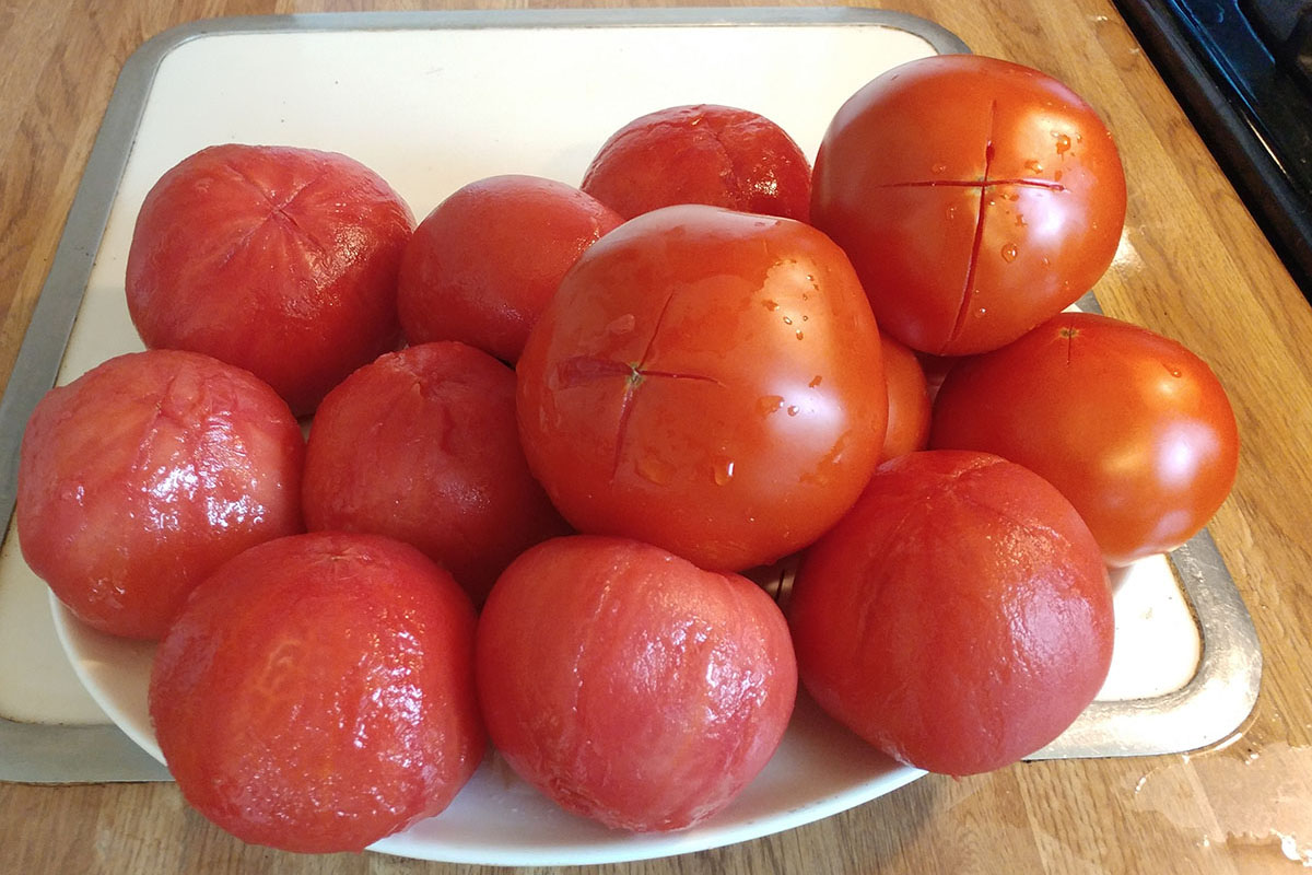Tomatoes are peeled in preparation of making canned tomatoes.