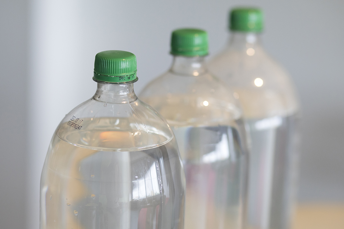Fill soda bottles with water instead of purchasing water from the grocery store in preparation of Hurricane Irma.