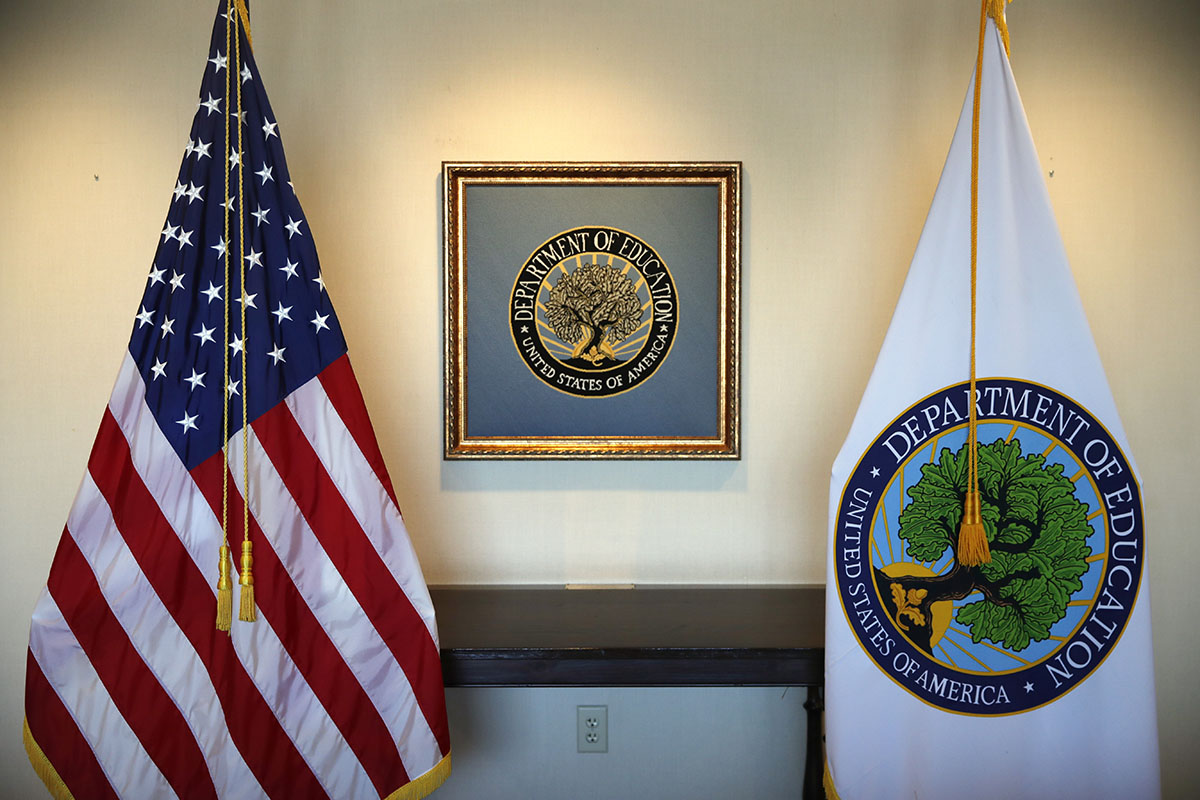 Flags decorate a space outside the office of Education Secretary Betsy DeVos, at the Education Department in Washington