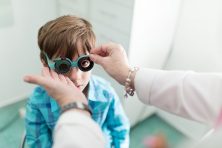 Boy doing eye test at optometrist