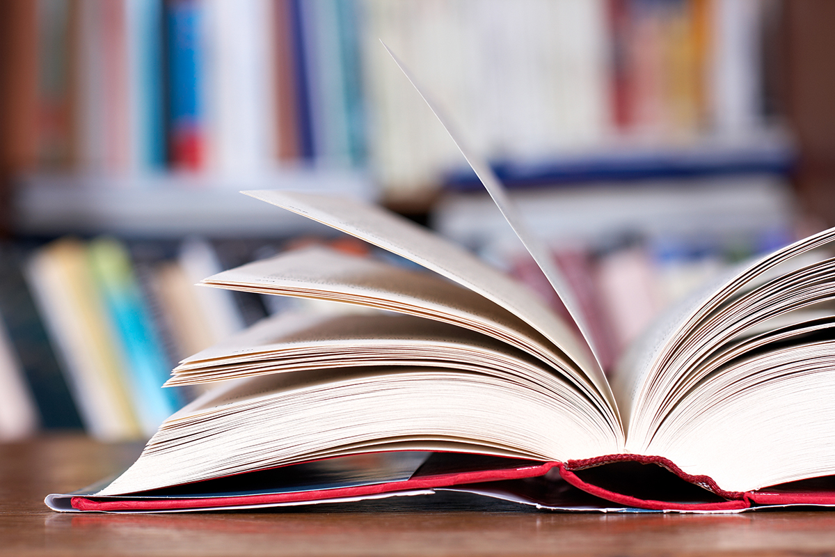A textbook is opened up at a library.