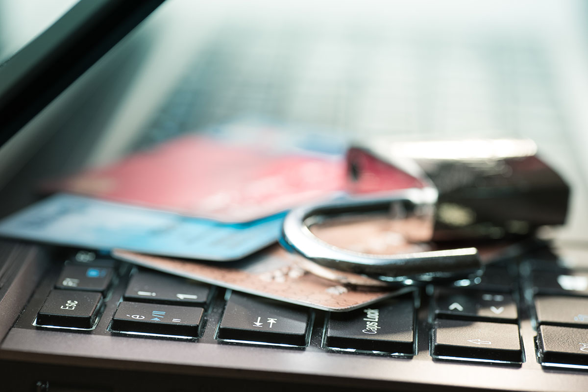 credit cards and lock on top of laptop keyboard