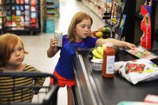 Liam Bedingfield, 4,left, and his sister, Lofta Bedingfield, 7, help their mom, Lisa Bedingfield, not pictured, check out at Safeway in Largo, Fla . Tina Russell / The Penny Hoarder