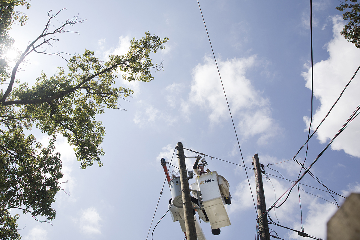 Mark Boyer, a lineman from Ameren Missouri, helps restore power on Woodlawn Circle West after Hurricane Irma hit .