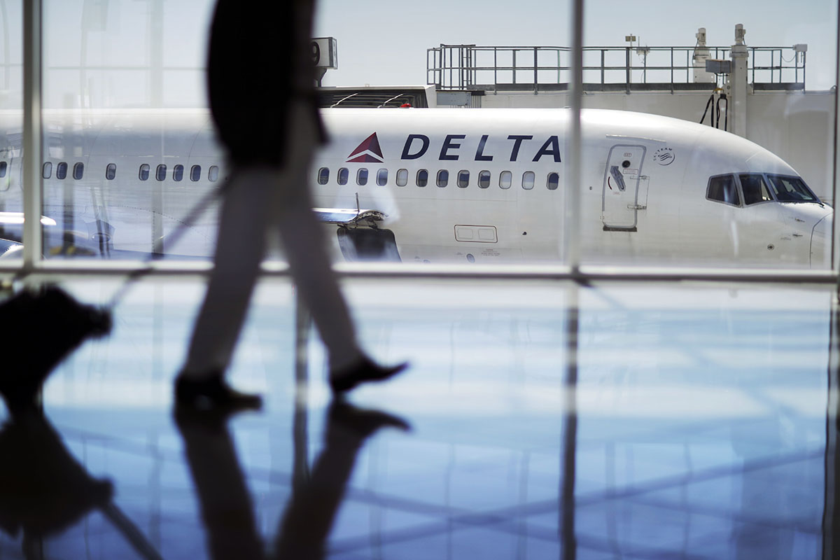 a Delta Air Lines jet sits at a gate at Hartsfield-Jackson Atlanta International Airport in Atlanta