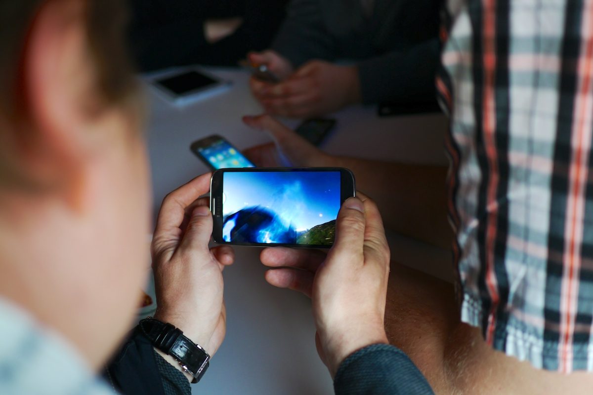 A man holds a Samsung Galaxy phone.