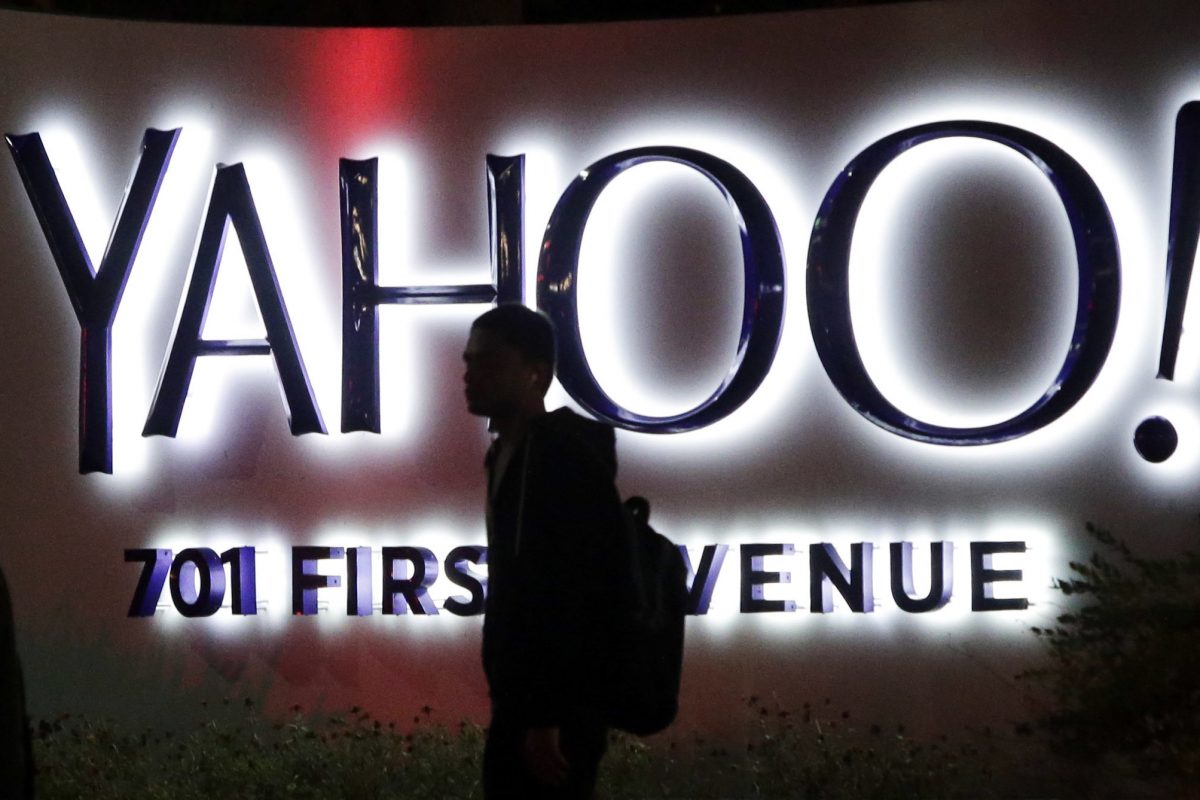 A person walks in front of a Yahoo sign at the company's headquarters in Sunnyvale, Calif. AP Photo/Marcio Jose Sanchez