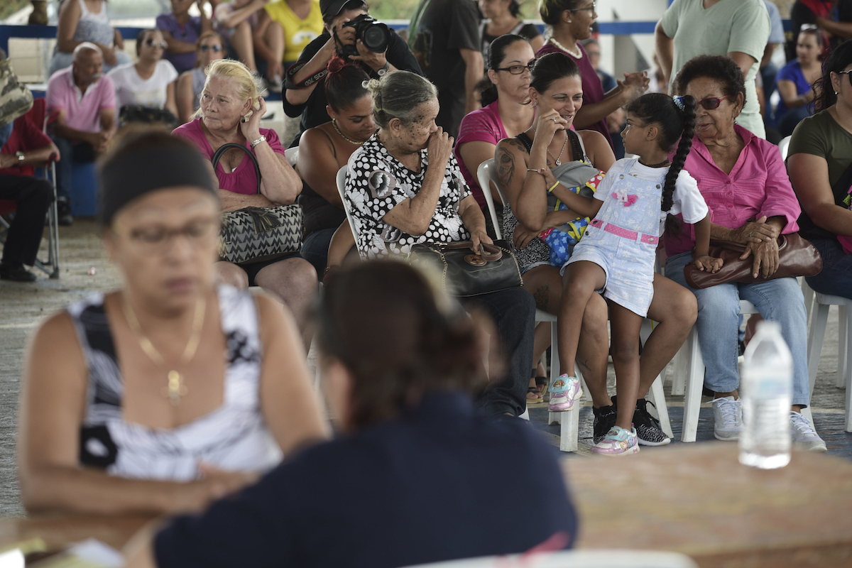 People wait at the Jose de Diego Elementary School to file FEMA forms for federal aid in the aftermath of Hurricane Maria in Las Piedras, Puerto Rico on Oct. 2, 2017. AP Photo/Carlos Giusti