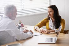 Shot of a doctor meeting with his young female patient