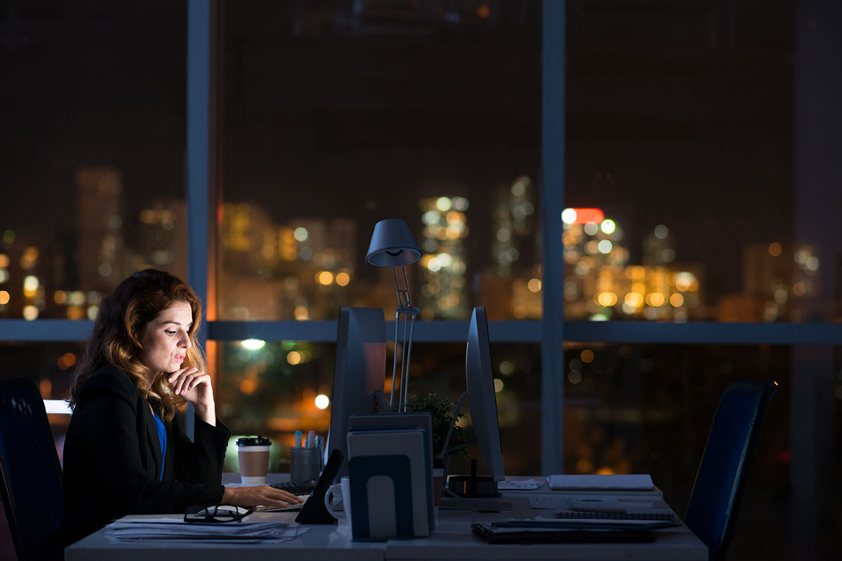 business woman working alone in dark office