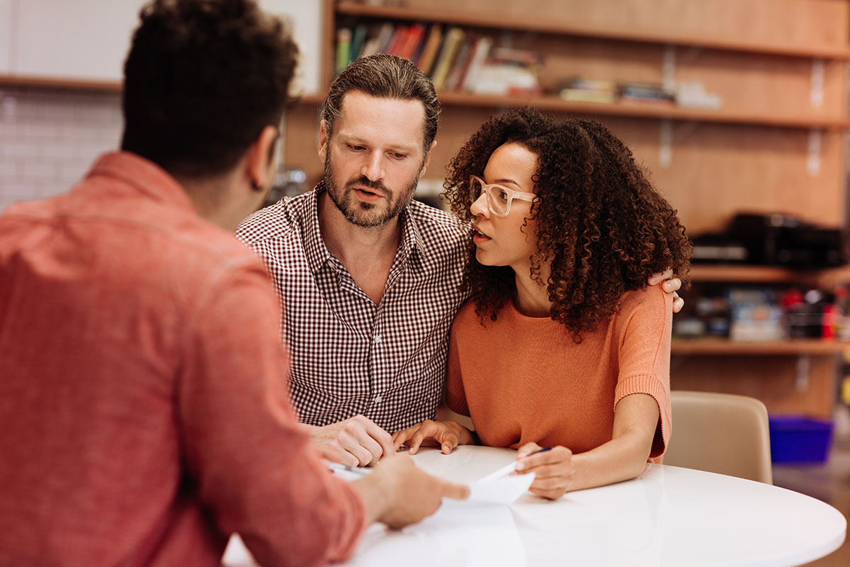 Couple consulting with agent