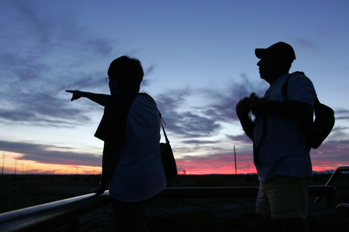 Fern Teems, left, points to what she believes may be one of the mystery lights near Marfa, Texas, as her husband James Teems looks on on June 1, 2005.