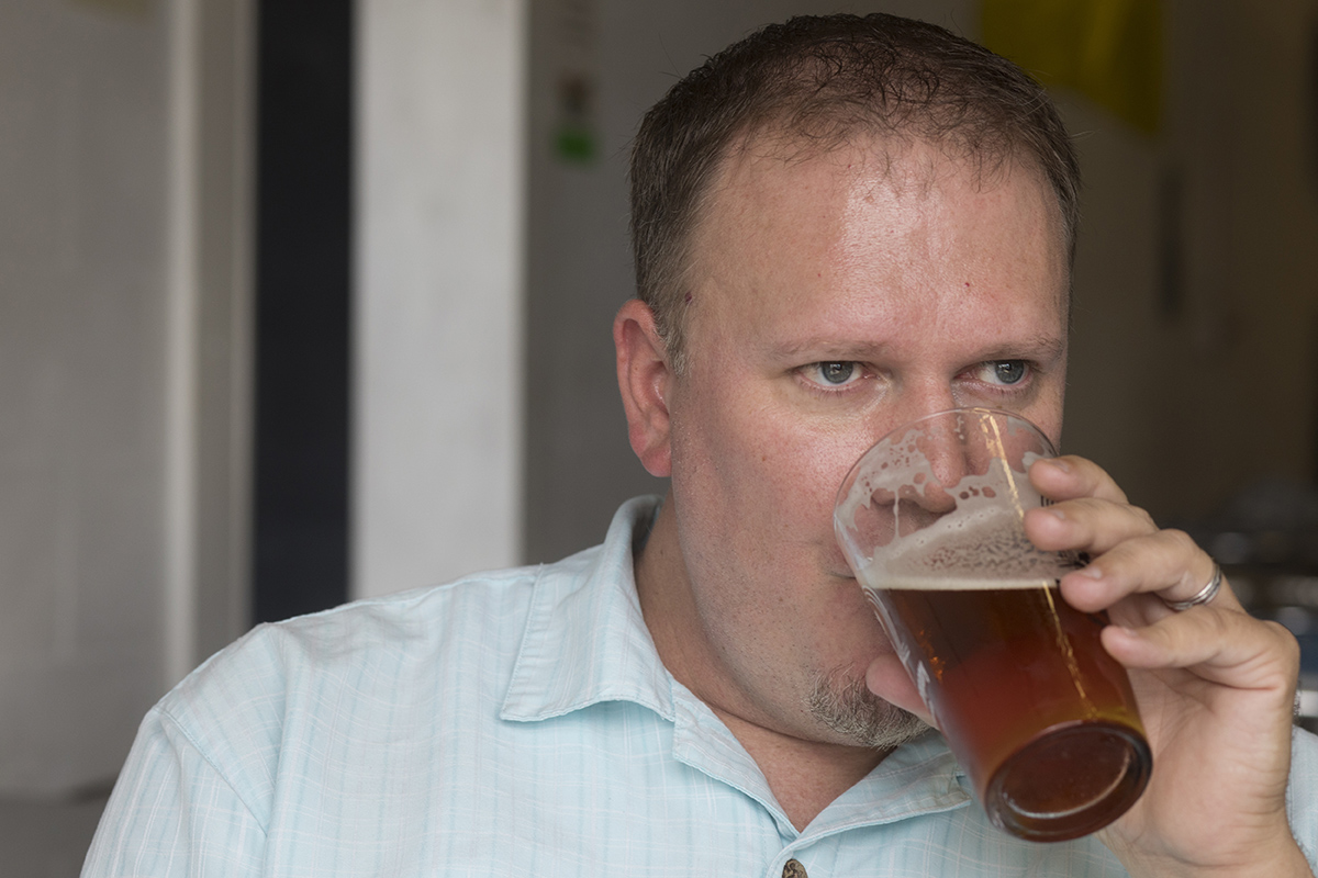Tyler Omoth drinks a beer at Rapp Brewing Company in Seminole, Florida.
