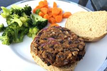 an open-faced burger made of TVP with a side of vegetables