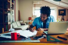 a man working at a laptop in a work space