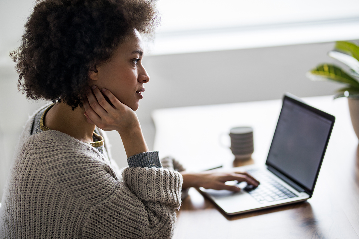 A woman checks her credit on the computer.