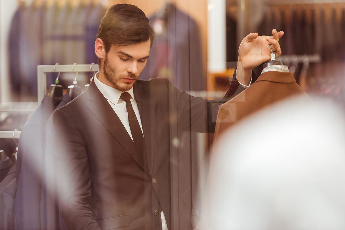 young man shopping for suits