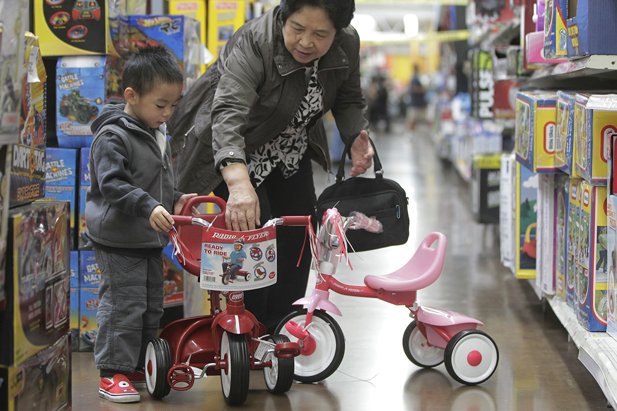 Feng De Tong, right, shops for an American made Radio Flyer tricycle for her grandson, Jayden Hu, 2, at Walmart Supercenter store in Rosemead, Calif.